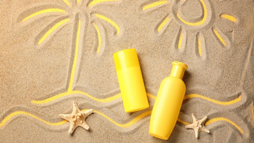 sunscreen with a palm tree drawn in the sand