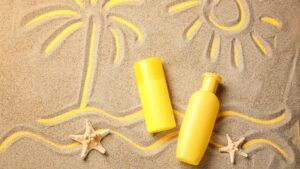 sunscreen with a palm tree drawn in the sand