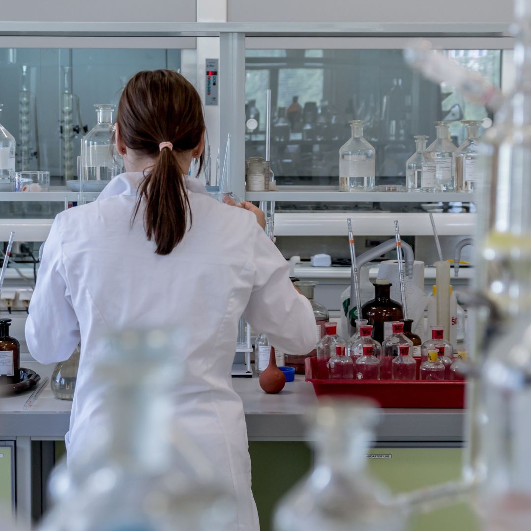 Woman using equipment to test substances.